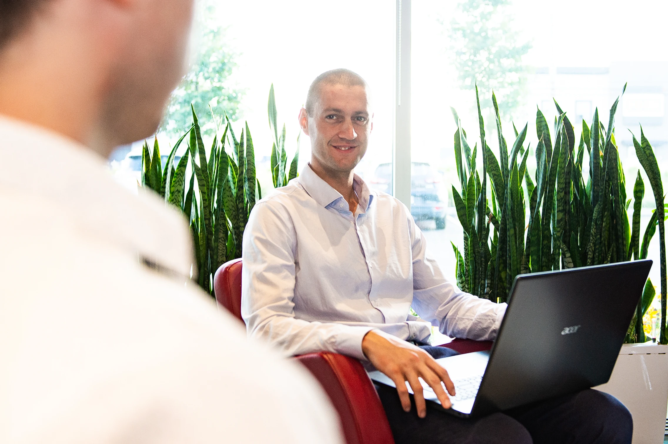 Professional portrait of Luc Létourneau with a laptop.