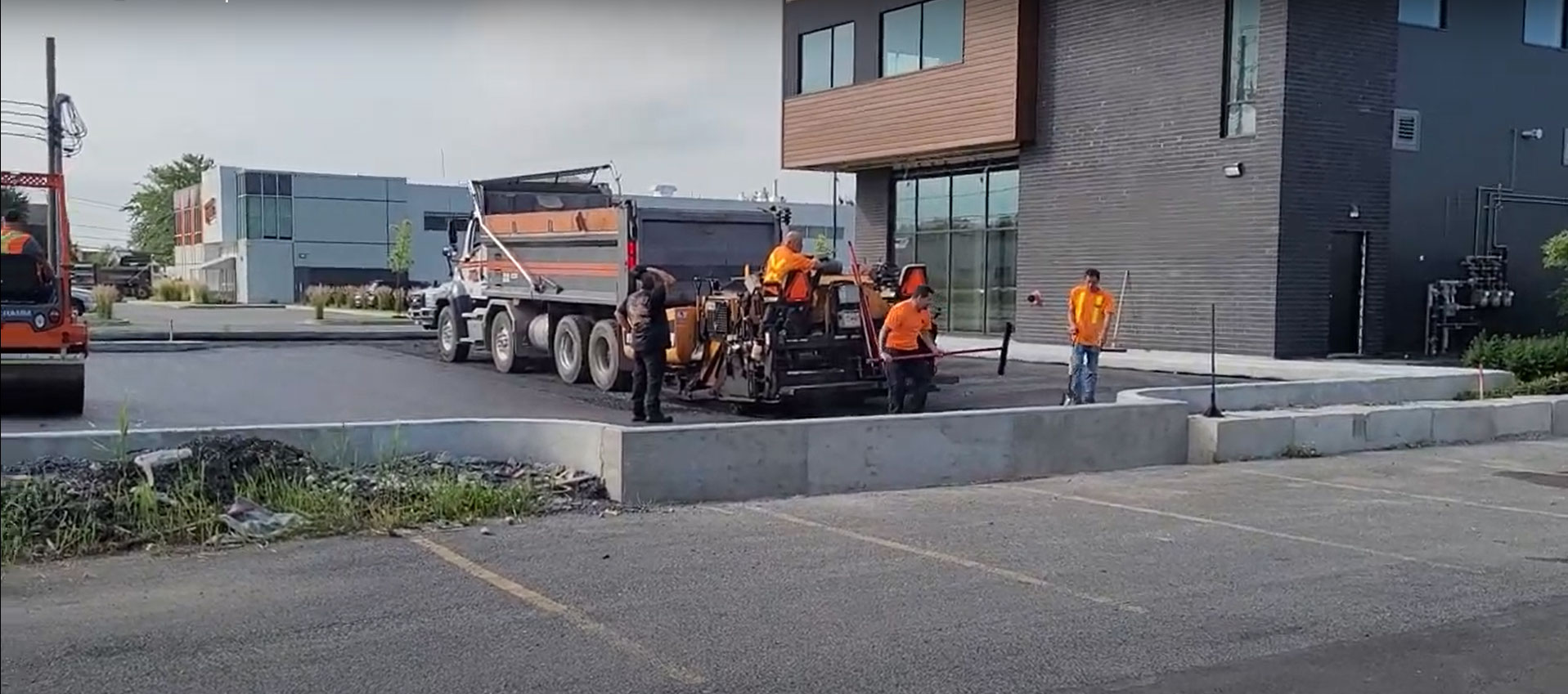 Protech Construction general contractors laying asphalt at a project site.